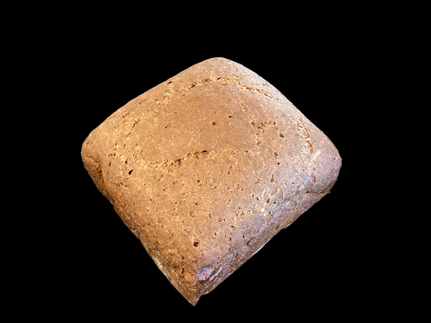 Half loaf of dark pumpernickel rice bread