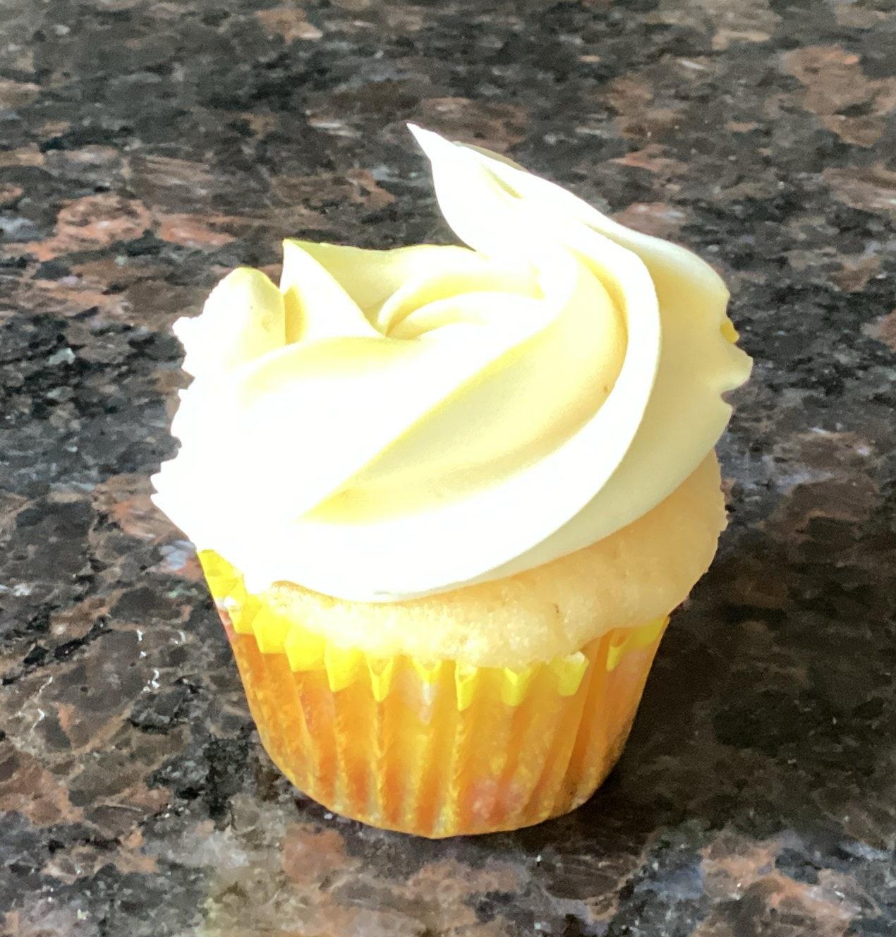 Mini lemon cupcake with vanilla buttercream frosting