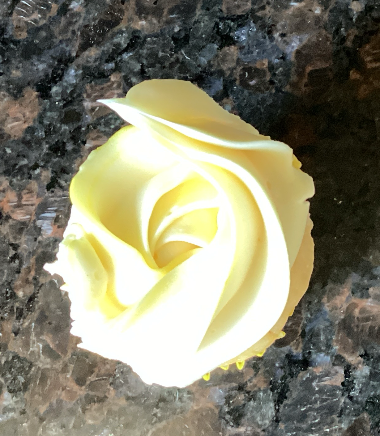 Mini lemon cupcake with vanilla buttercream frosting